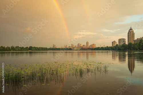 Obolon district near the Dnieper river with dramatic clouds and a rainbow, Kiev, Ukraine © underwaterstas