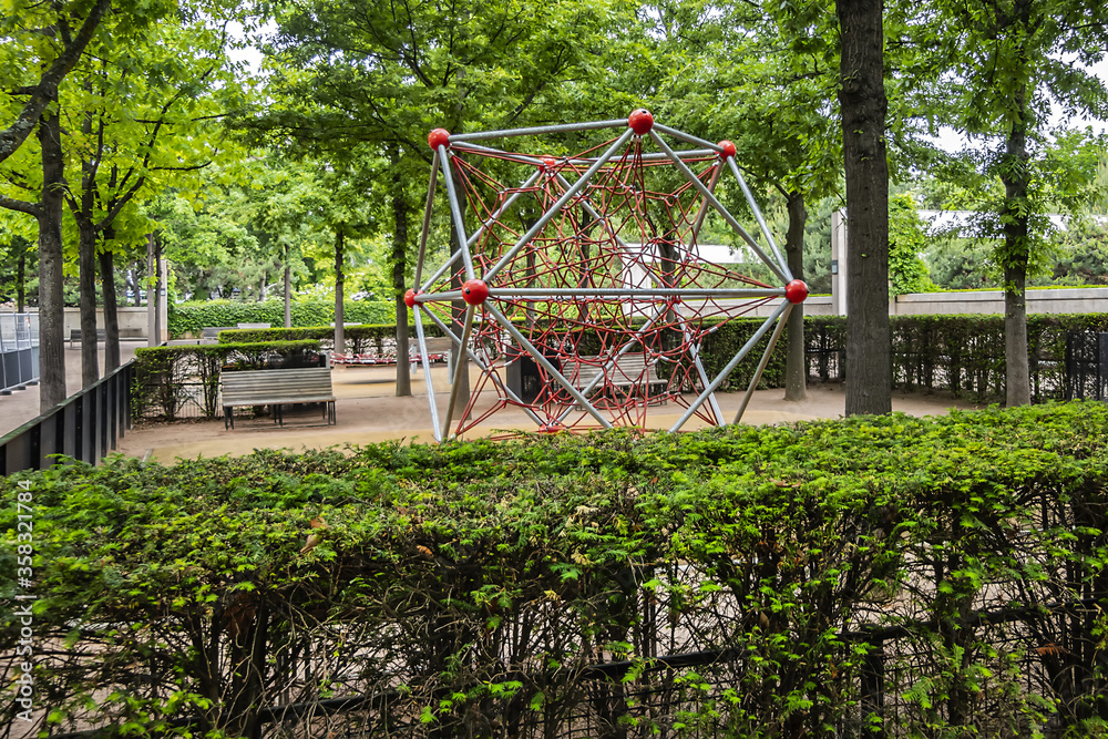 Garden Eugenie-Djendi (former Black Garden) - 2 hectares public parc between St. Charles Street (rue Saint-Charles) and Leblanc street (rue Leblanc) with a bushy vegetation. Paris, France. Garden Eugenie-Djendi (former Black Garden) - 2 hectares public parc between St. Charles Street (rue Saint-Charles) and Leblanc street (rue Leblanc) with a bushy vegetation. Paris, France.