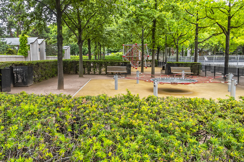 Fototapeta Naklejka Na Ścianę i Meble -  Garden Eugenie-Djendi (former Black Garden) - 2 hectares public parc between St. Charles Street (rue Saint-Charles) and Leblanc street (rue Leblanc) with a bushy vegetation. Paris, France.