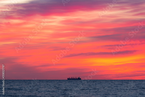 Horizon's Edge: Minimalistic Sunrise Seascape with a Ship © Andrii