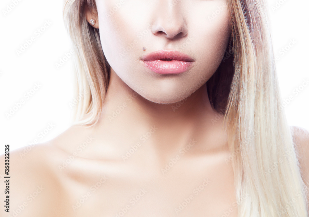 Lips. Part of face of model girl with perfect clean skin. Natural nude make-up. Isolated over white background. Skincare facial treatment concept Lips. Part of face of model girl with perfect clean skin. Natural nude make-up. Isolated over white background. Skincare facial treatment concept