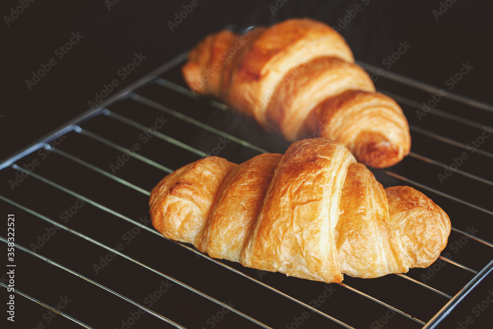 Dark mood background and fresh croissants on board. Dark mood background and fresh croissants on board.