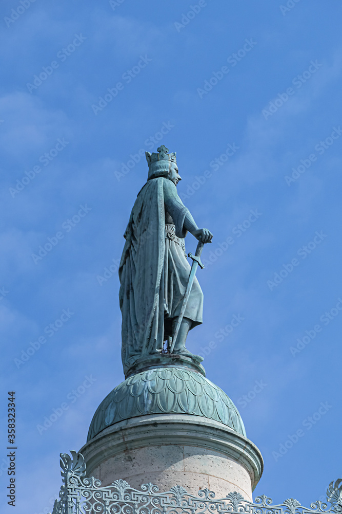 Fototapeta premium The Throne Barrier and two columns were constructed as part of Wall of Farmers General back in 1700s by Place de la Nation. Saint-Louis statue on the north column. Paris, France.