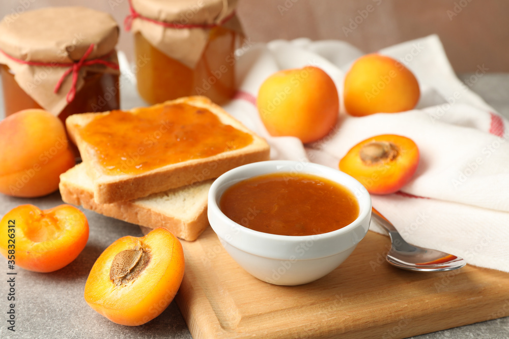 Composition with apricot jam on gray table, close up Composition with apricot jam on gray table, close up