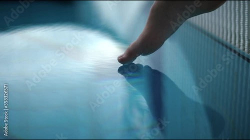 Extra close up view of foot that touches the water in pool