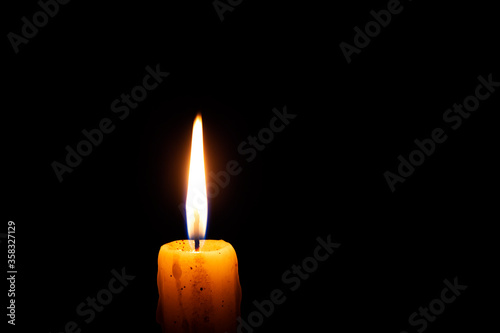 Burning candle in the dark. Copy space