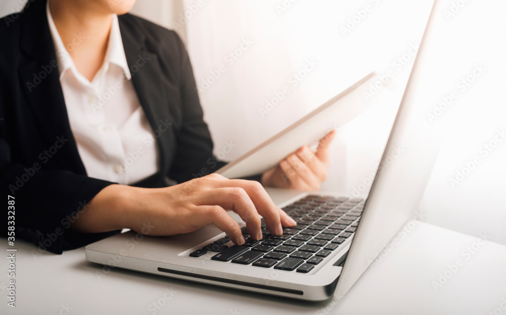 businesswoman hand using smart phone, tablet payments and holding credit card online shopping, omni channel, digital tablet docking keyboard computer at office in sun light with film grain effect businesswoman hand using smart phone, tablet payments and holding credit card online shopping, omni channel, digital tablet docking keyboard computer at office in sun light with film grain effect