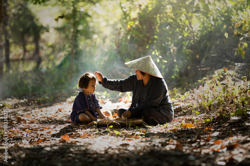 Fotografie The lady farmer pat her daughter head and talk to her daugther during prepare th