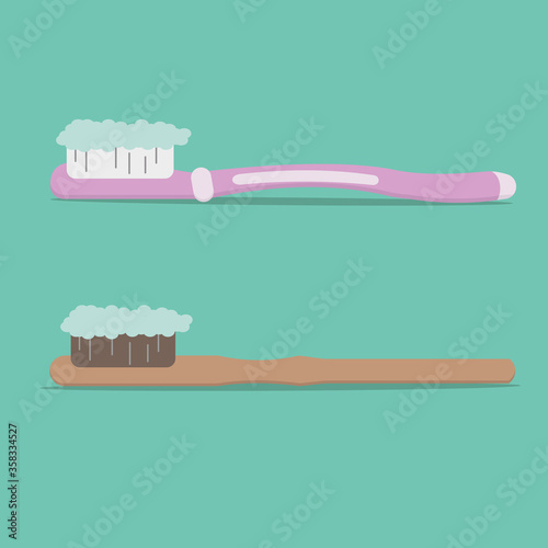 Two toothbrushes - from plastic and an eco-brush with natural villi and toothpaste on them