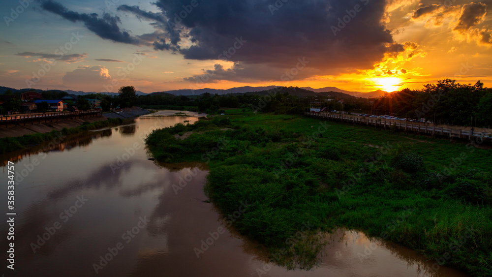 Obraz premium The aerial view of river deltas or sand bar with the background dramatic sunset.