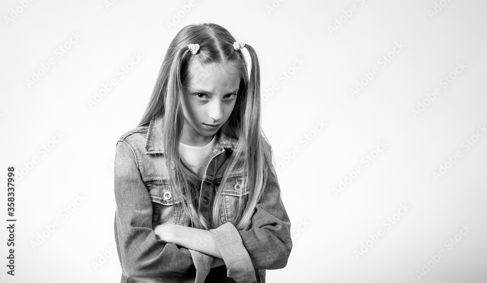Black and white photo of an angry girl with long hair on a light background. Next to the girl is a place for text. Black and white photo of an angry girl with long hair on a light background. Next to the girl is a place for text.