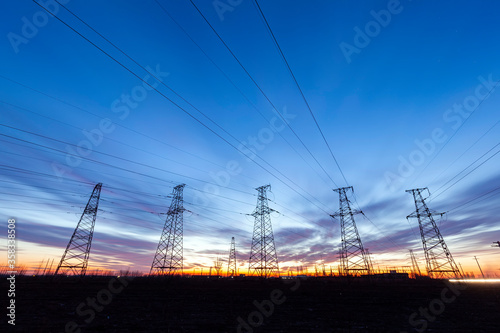 In the evening, the high voltage tower and the beautiful sunset glow