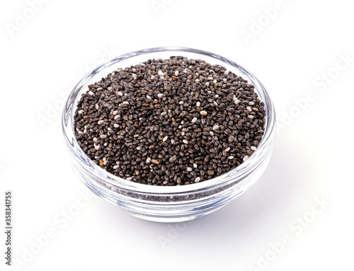 dark Chia seeds in a glass container isolated on a white background