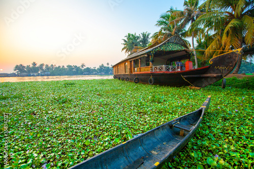 Beautiful sunset with houseboat in the backwaters of Kerala, India