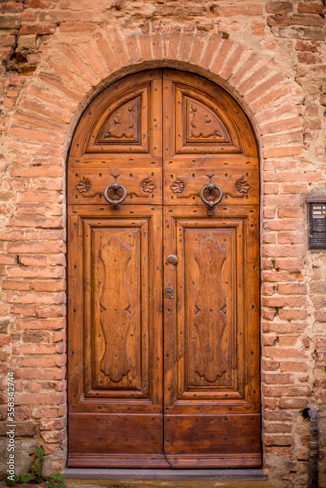 beautiful door in a street of old medieval village in Tuscany beautiful door in a street of old medieval village in Tuscany