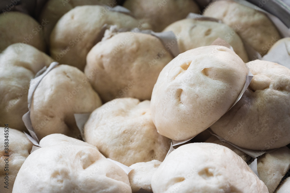 Homemade steamed pork buns in a steamer Homemade steamed pork buns in a steamer