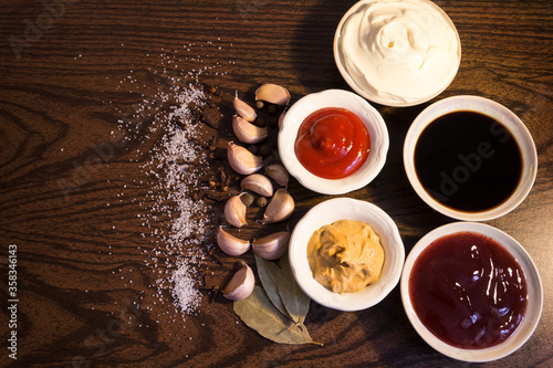 sauces and spices on a dark background.