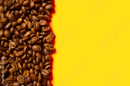 Texture of coffee beans. Roasted coffee beans background. close up Coffee beans with copy space on Orange background.