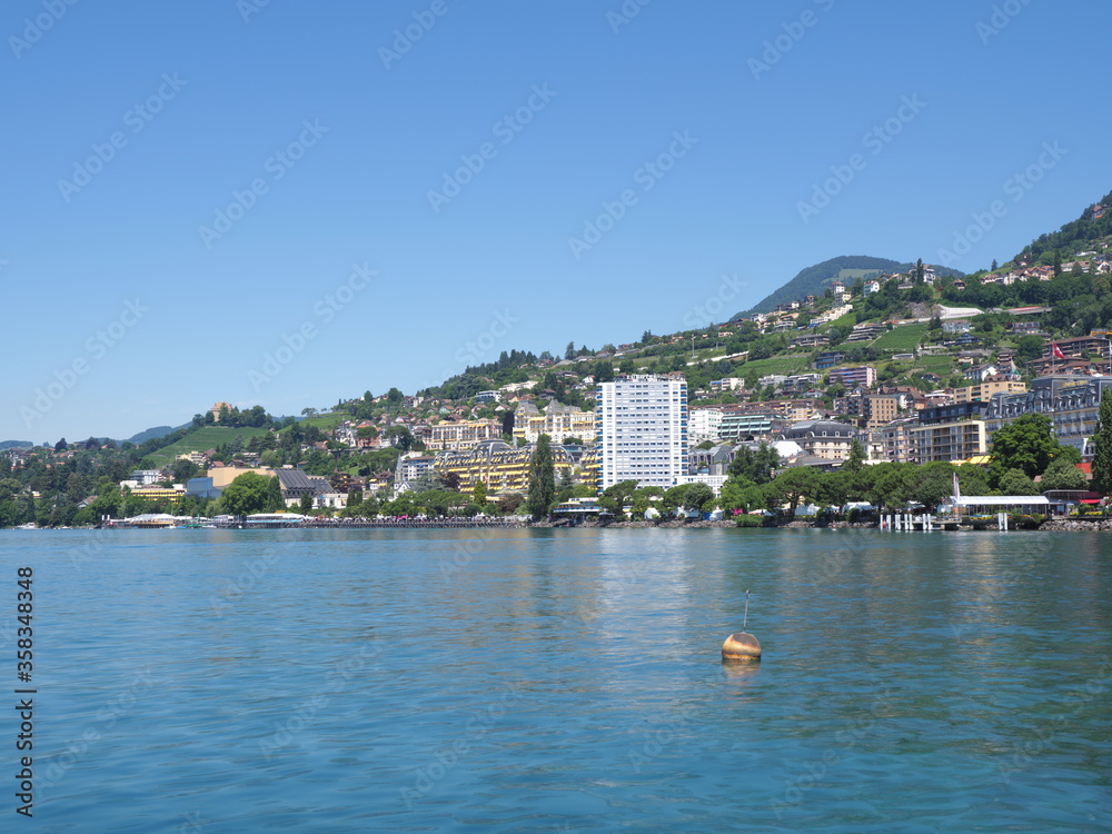 Landscapes of Lake Geneva and european Montreux city in canton Vaud in Switzerland, clear blue sky in 2017 warm sunny summer day on July.