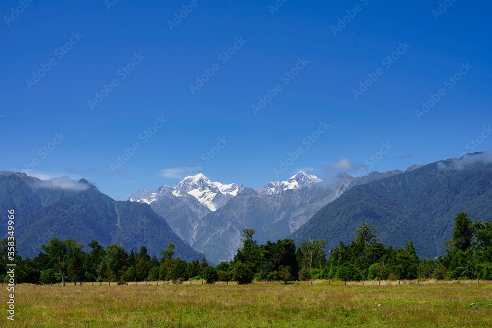 Landscape with Mt. Cook and Mt. Tasman in a blue sky - late summer.