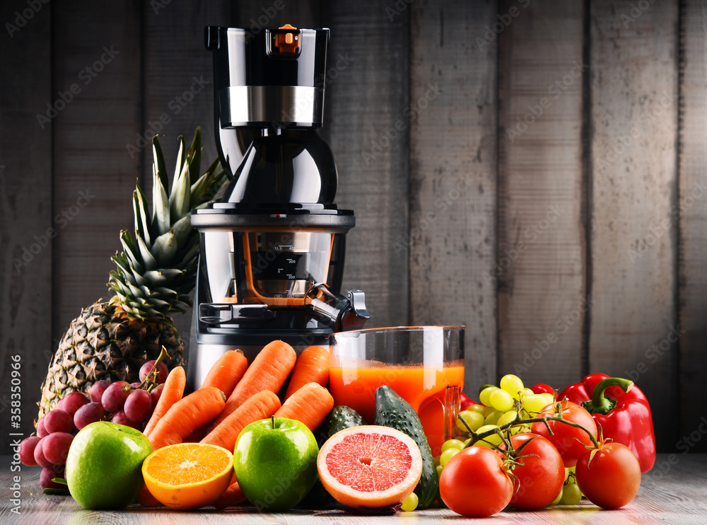 Slow juicer with organic fruits and vegetables. Slow juicer with organic fruits and vegetables.