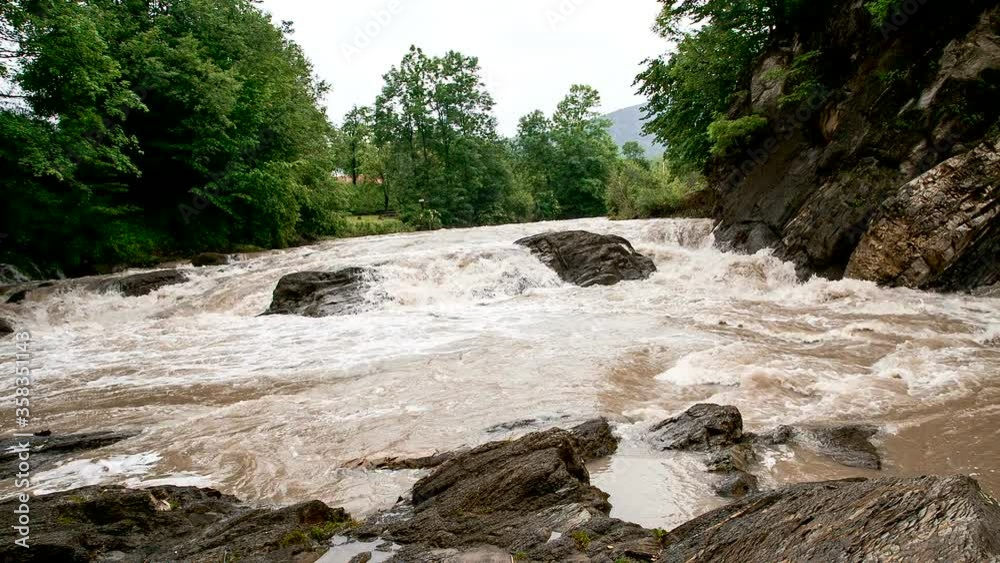 The rapid flow of the river among the rocks and stones