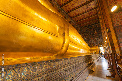 The reclining buddha temple in wat phra chettuphon wimon mangkhalaram ratchaworamahawihan or Wat Pho Golden Big buddha statue under construction and repaired by skilled technicians in BANGKOK/THAILAND photo