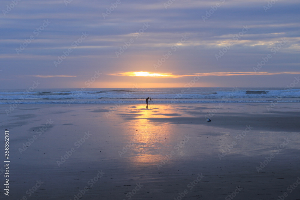 Sunset over the pacific ocean. Photographer ashore. Oregon. USA.