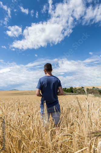 A Man Stand In The Middle Of Grain Field