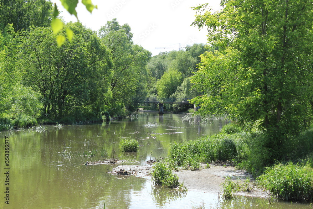 View of the river and the old bridge for pedestrians. Russia.