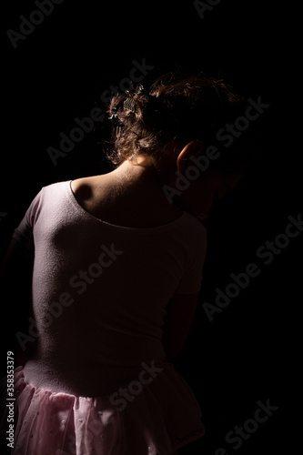 Little Ballerina Girl in Black Background 