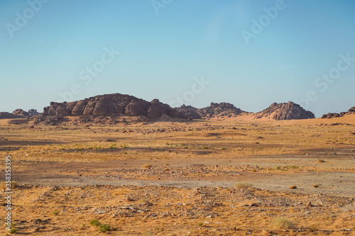 bleak desert landscape with mountain and rock formations