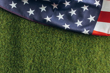 top view of american flag on green grass outside, labor day concept