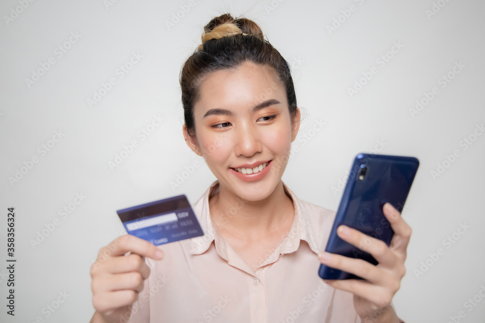 Asian women are checking credit card points using a mobile phone.
Asian women are checking credit card points using a mobile phone.