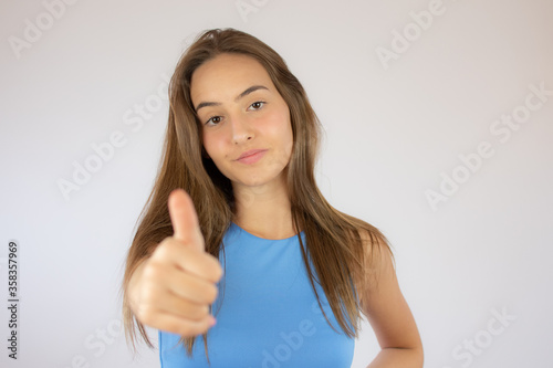 Beautiful young girl making finger up gesture