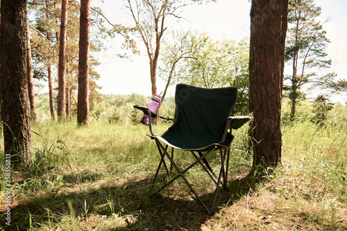 folding camp chair for a picnic in the pine forest in the morning