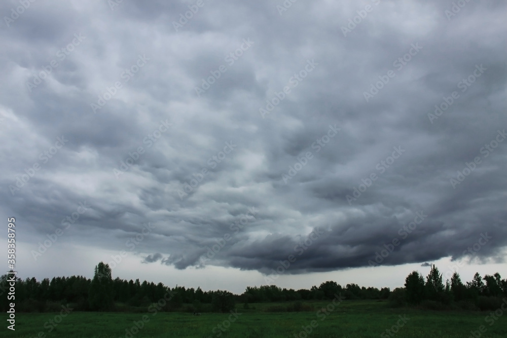 Dark rain clouds above the field Dark rain clouds above the field