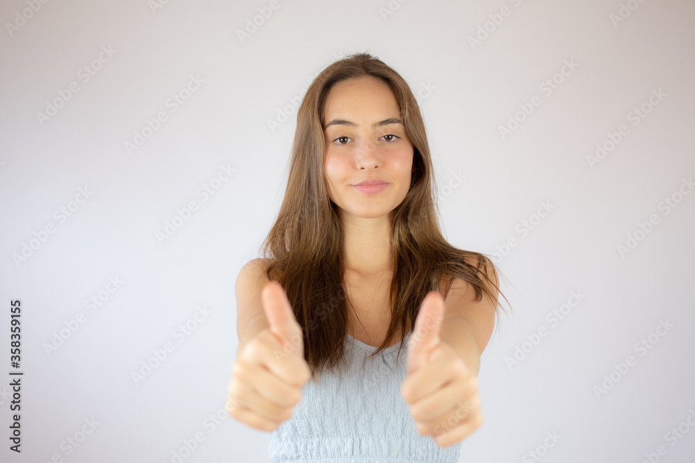 Pretty young girl making fingers up gesture Pretty young girl making fingers up gesture