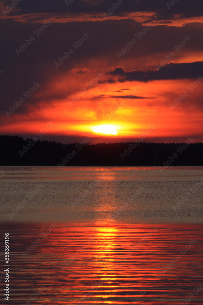 Red sunset reflecting in calm water