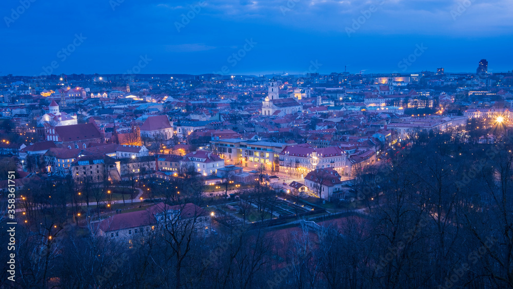 Evening panorama of Vilnius city in Lithuania with night illumination. Top View.