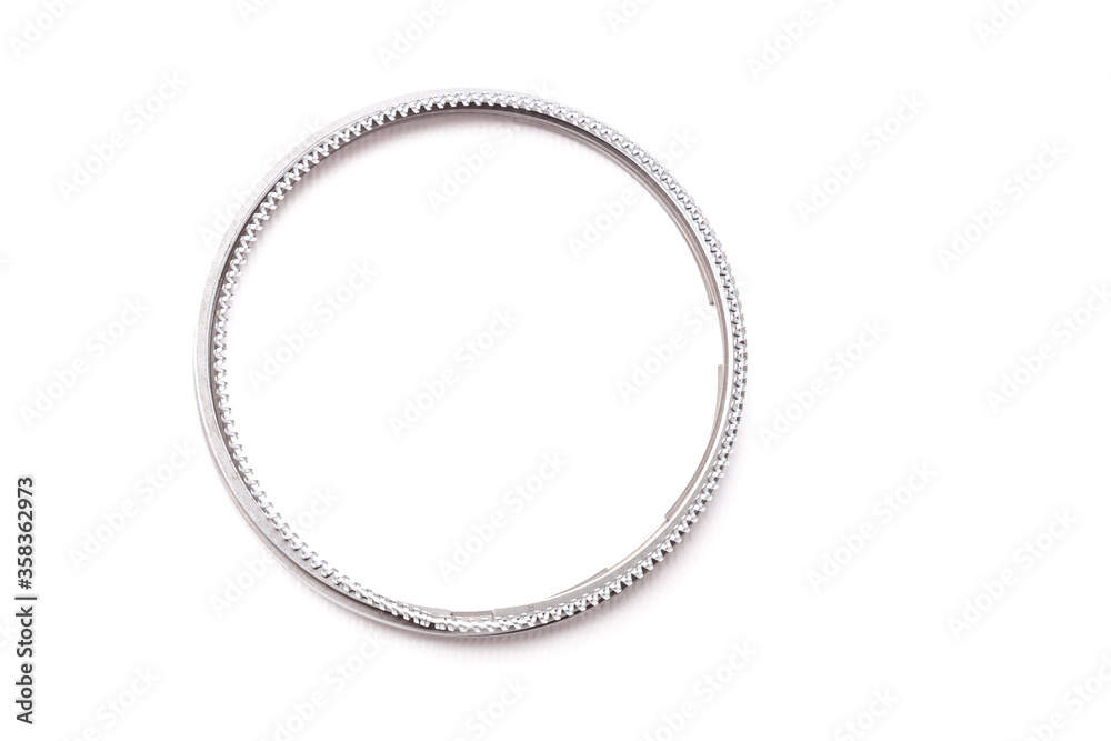 Metal chromed piston rings for car engine repair on a white isolated background in a photo studio. Sale of auto parts in a car service. Metal chromed piston rings for car engine repair on a white isolated background in a photo studio. Sale of auto parts in a car service.