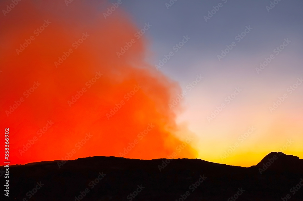 Colorful sunrise on Erta Ale Volcano illuminated with red lava smoke, Danakil Depression, Ethiopia, Africa