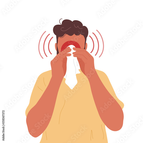 Young man blowing nose into handkerchief