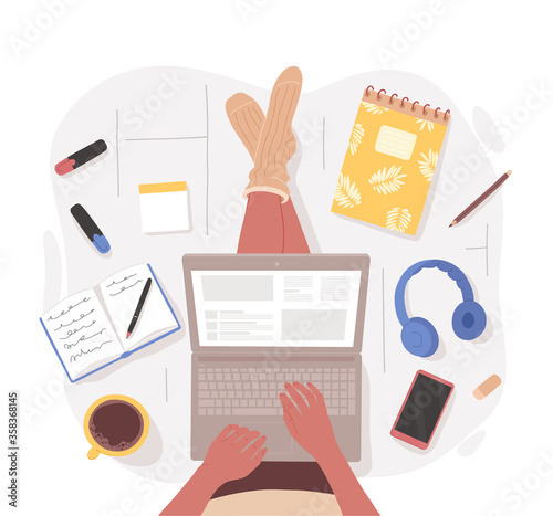 Woman sitting on floor crosslegged with laptop