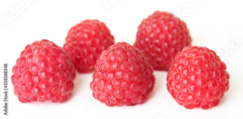 Large juicy raspberries on a white background.