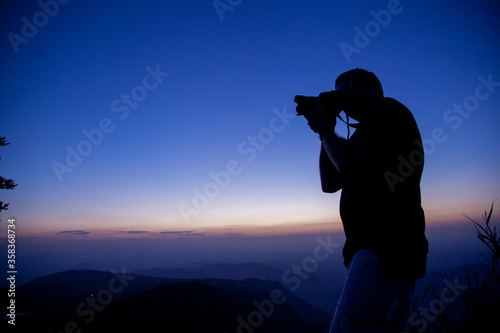 Man taking picture of sunset at Pico Alto em Guaramiranga, Ceará, Brazil