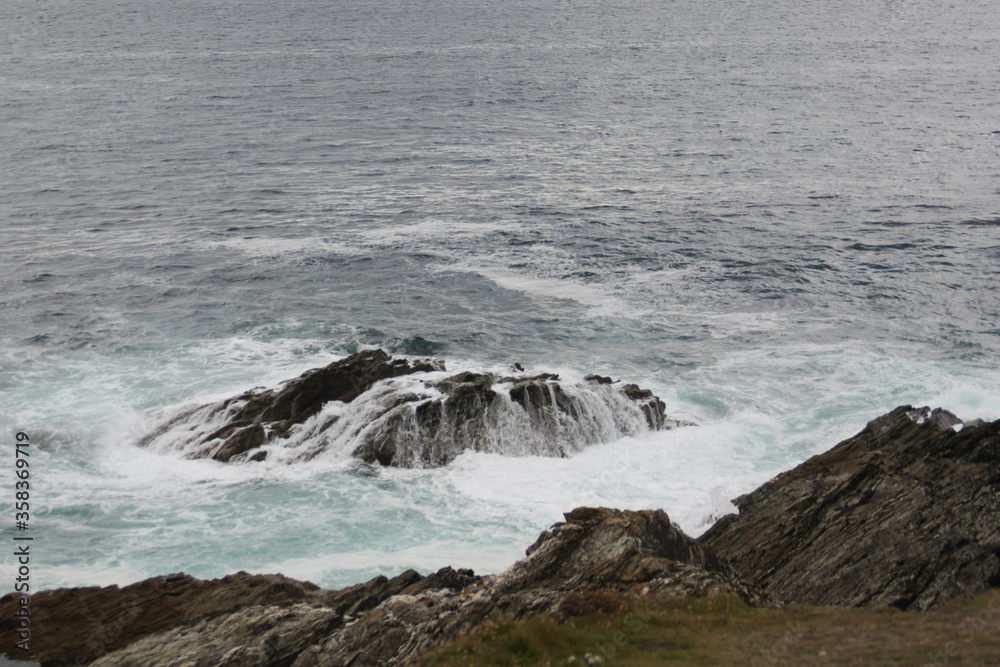 Waves crashing on rocks in Cornwall