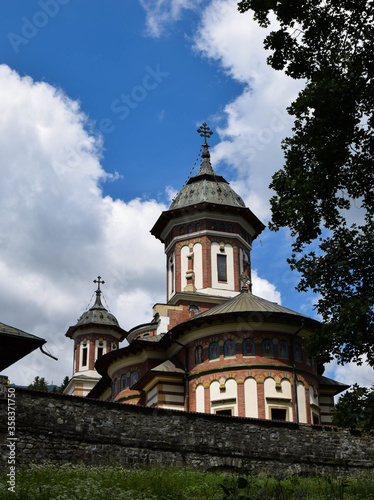 Stone religious building of Christian Orthodox church built in the Byzantine style. Old Orthodox Monastery with a beautiful architecture. Romania, Sinaia.