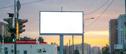 Advertising billboard advertising large horizontal screen MOCKUP for advertising. Against the background of the sunset, glowing. photo