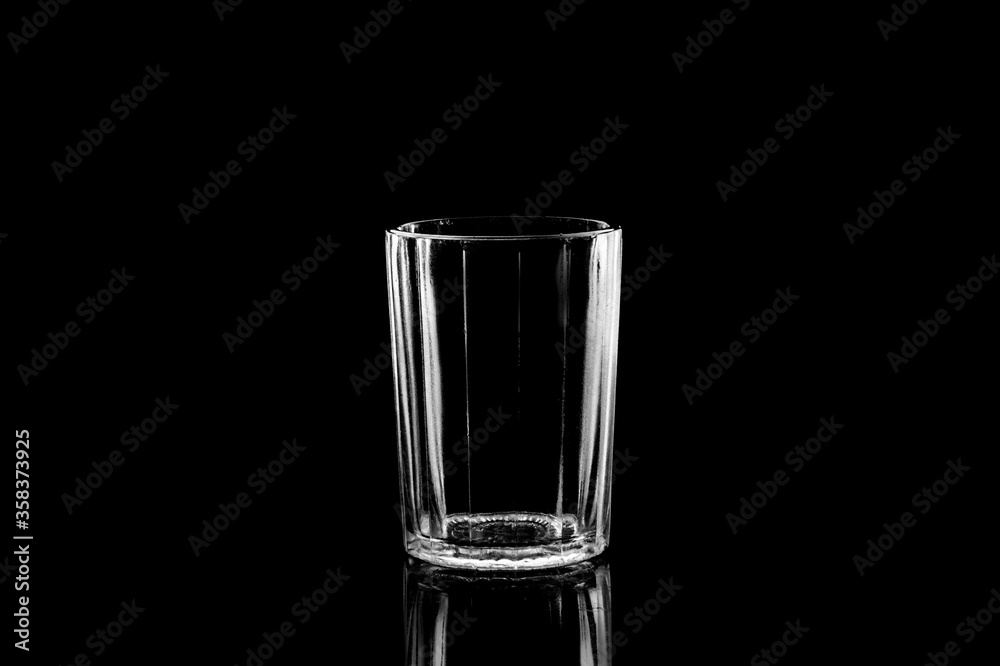 Low-key Studio Shot of a White silhouette of a faceted glass light glasses isolated on a black Background. Smooth lines and shapes. . Low-key Studio Shot of a White silhouette of a faceted glass light glasses isolated on a black Background. Smooth lines and shapes. .